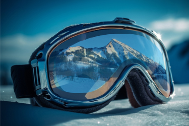 goggles in the snow reflecting Crested Butte mountain
