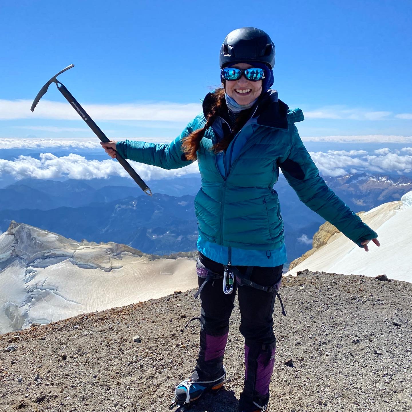 Michelle holding an ice axe on a mountain